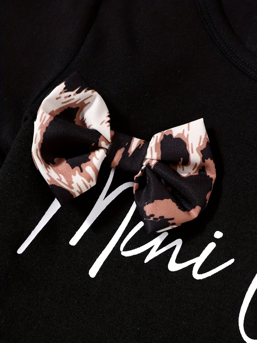 Black baby tee with leopard print bow accent and white script text