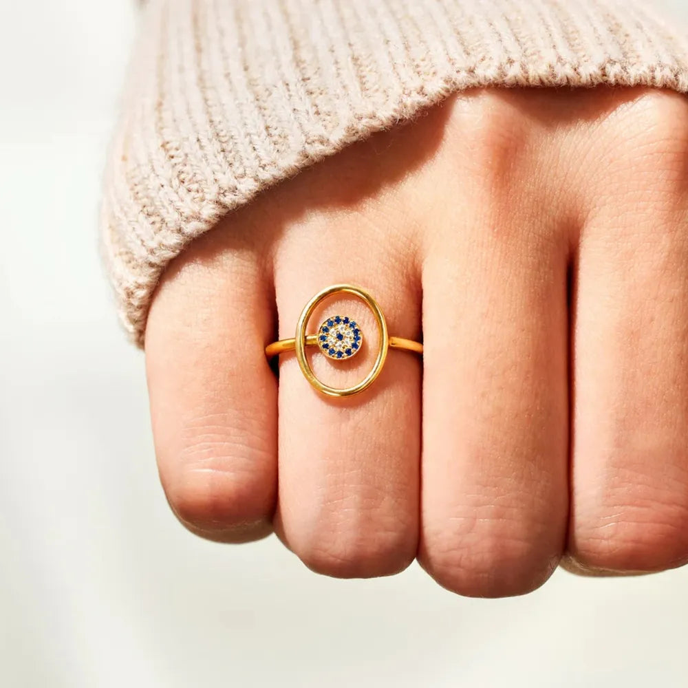 Gold oval ring with blue evil eye detail