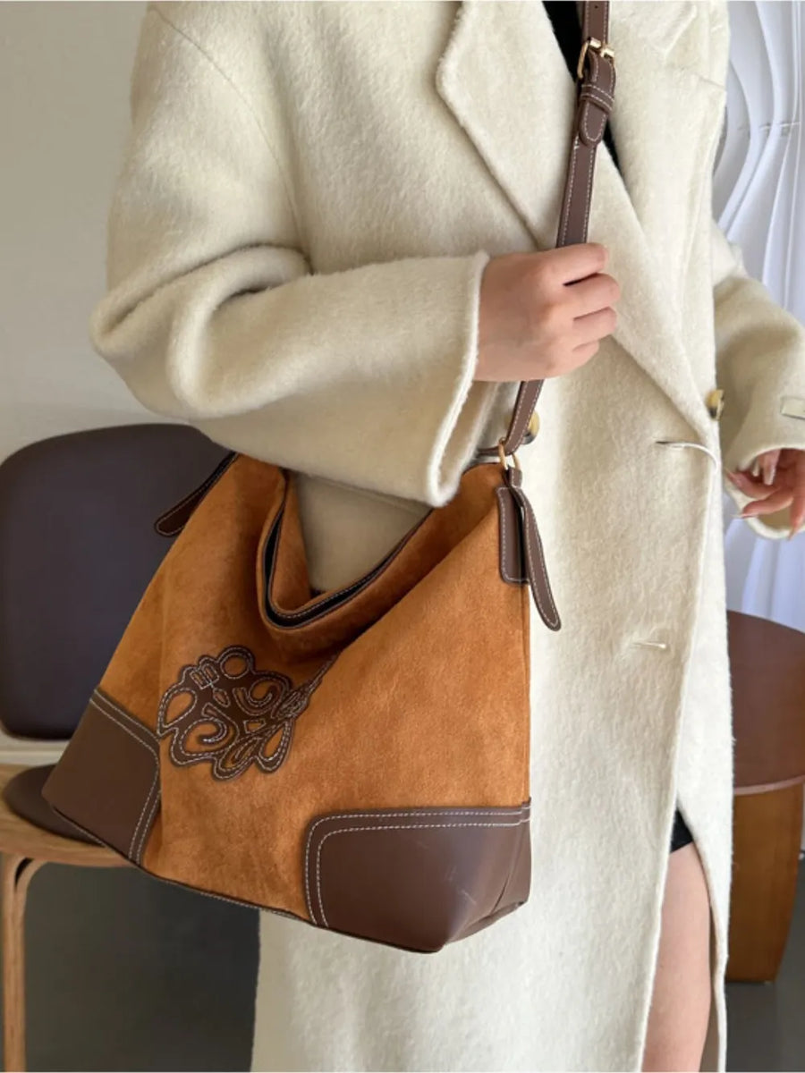 Ochre suede hobo bag with brown leather trim and contrast stitching.