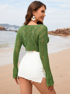 Green crochet tie-front shrug with open knit diamond pattern and long sleeves.