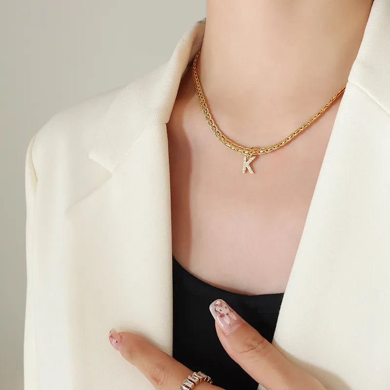 Gold pavé initial K charm necklace on a braided chain, 18K gold-plated brass.