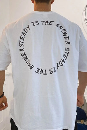 White oversized t-shirt with black circular text graphic on back
