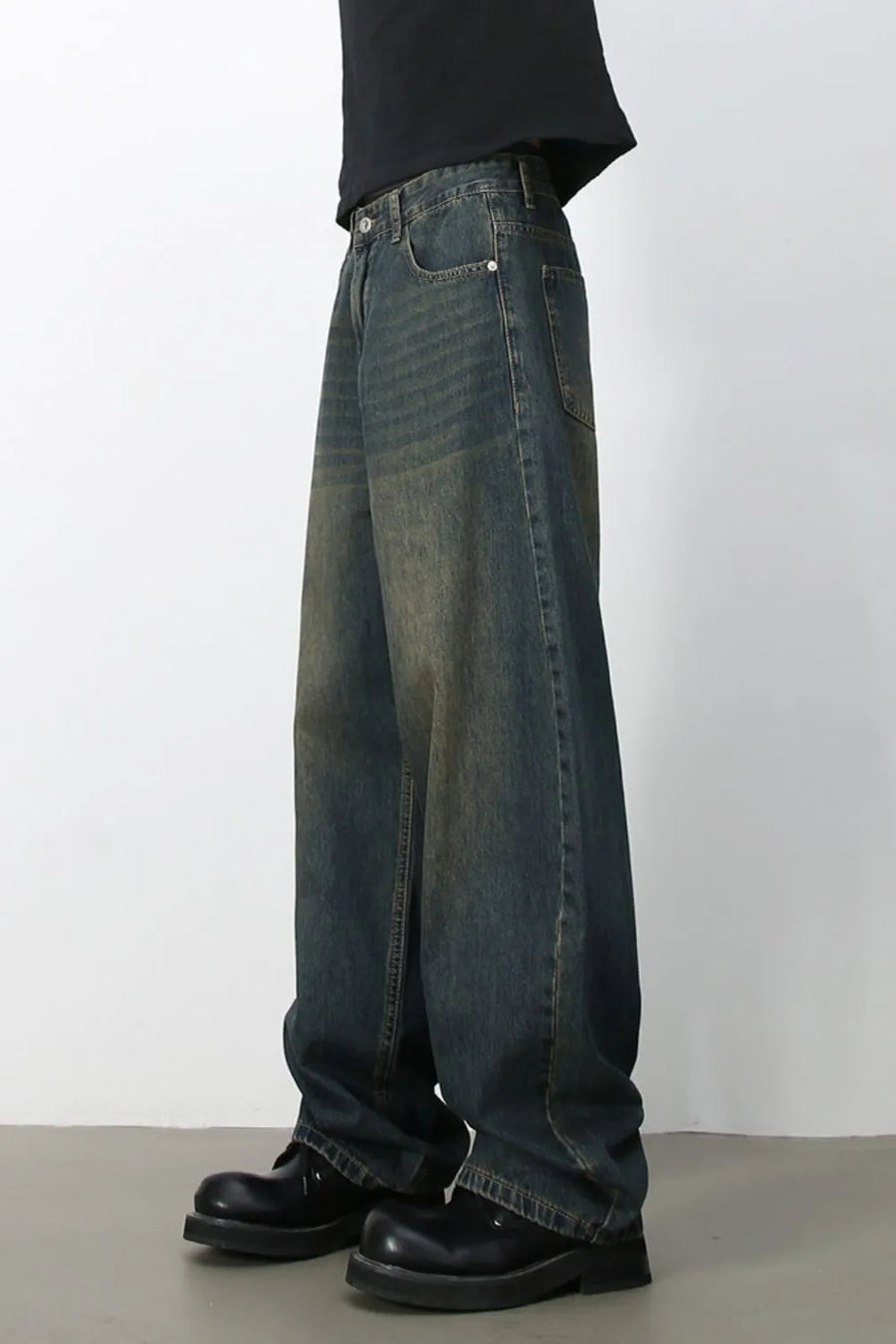 Faded baggy denim jeans in a dark blue wash with a relaxed fit.