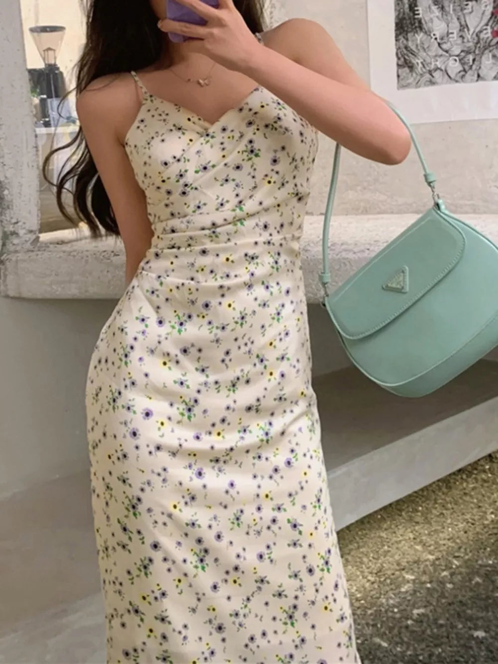 Floral ruched midi dress with spaghetti straps in beige with delicate purple and yellow flowers.