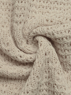Beige knit maxi dress fabric with open weave detail and textured pattern.