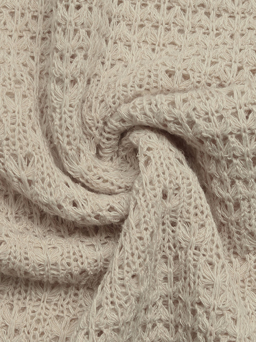 Beige knit maxi dress fabric with open weave detail and textured pattern.