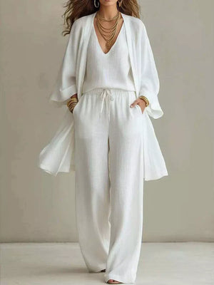 White linen wide leg pants with drawstring waist, V-neck tank top, and open front duster cardigan.