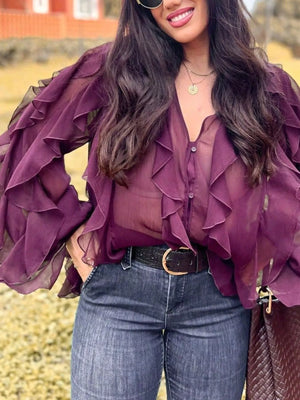 Burgundy sheer long-sleeve blouse with ruffled details and button front.