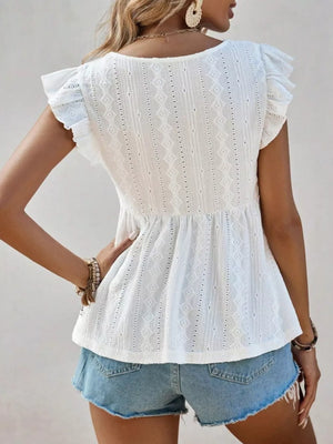 White eyelet blouse with ruffle sleeves and peplum hem, paired with denim shorts.