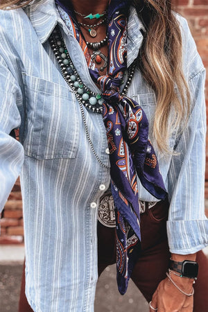 Light blue striped denim shacket with button-down front and chest pockets.