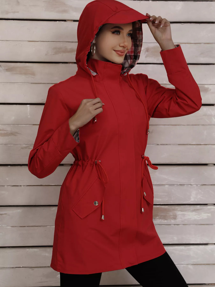 Red drawstring trench coat with hood and plaid lining, featuring snap pockets.