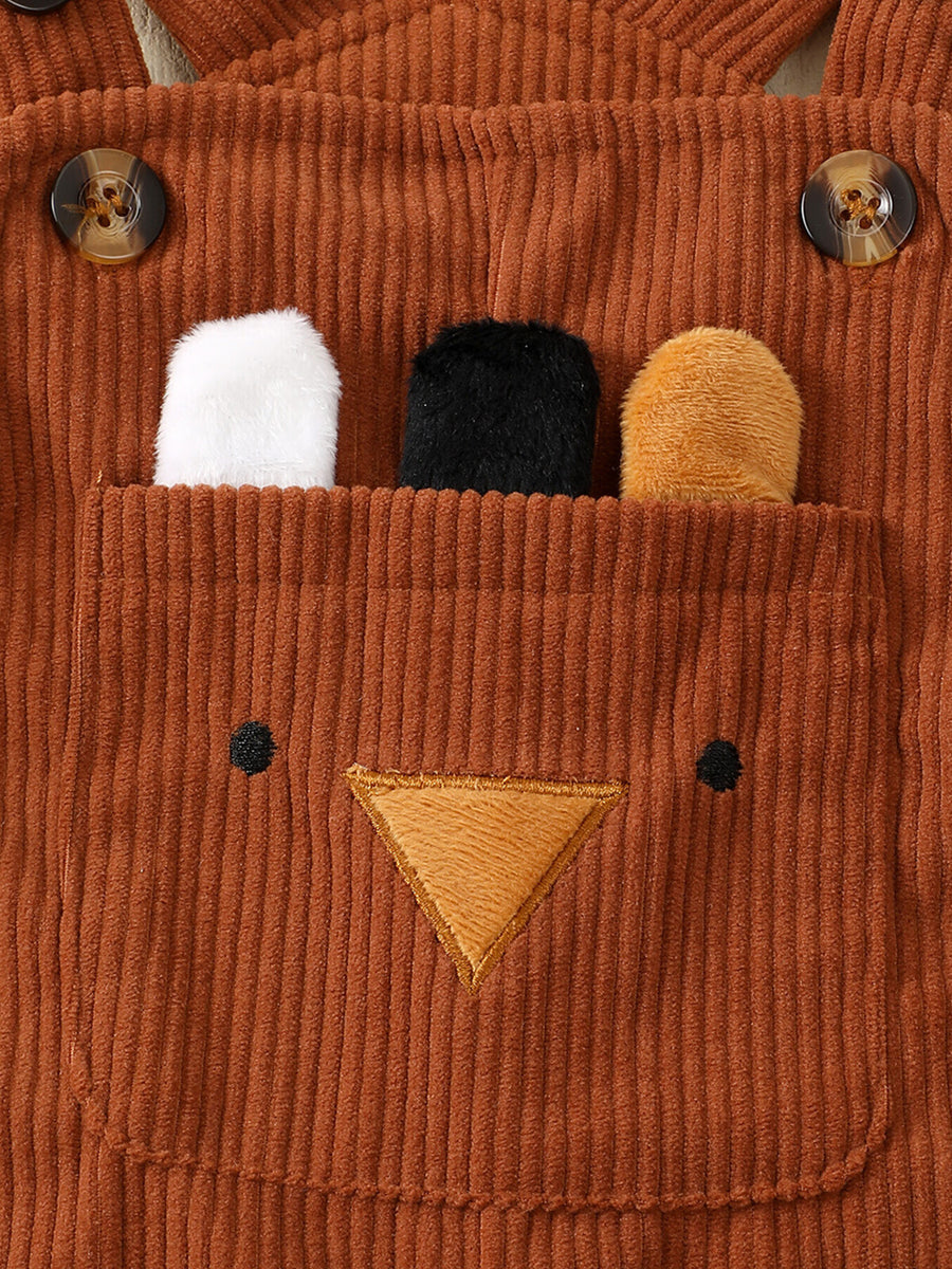 Brown corduroy overalls with bear face applique and plush ears peeking from pocket.