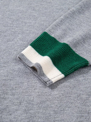 Gray ribbed V-neck sweater with green and white striped cuffs
