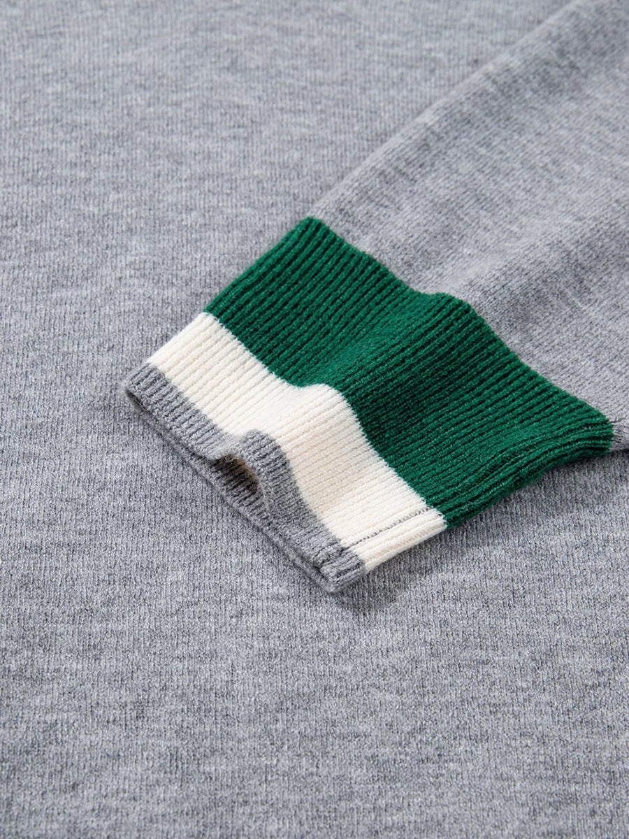 Gray ribbed V-neck sweater with green and white striped cuffs