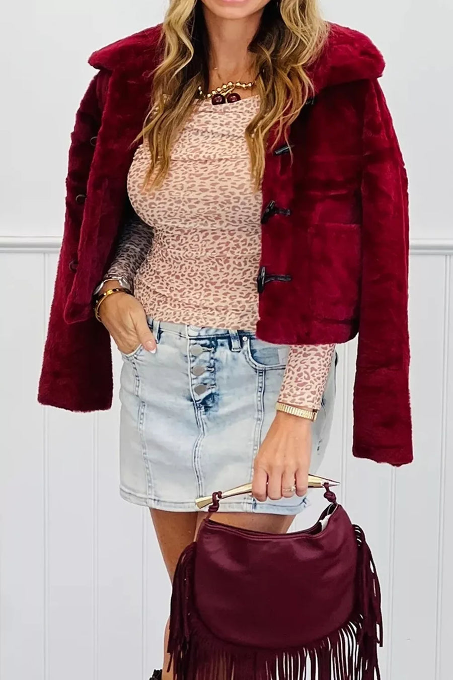 Leopard print mesh top with long sleeves and off-shoulder neckline.