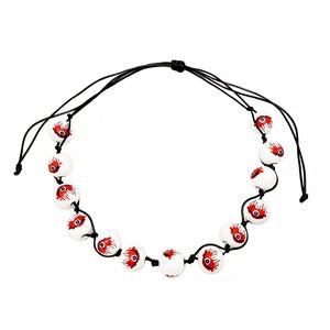 necklace in white with eyeball-print and beaded