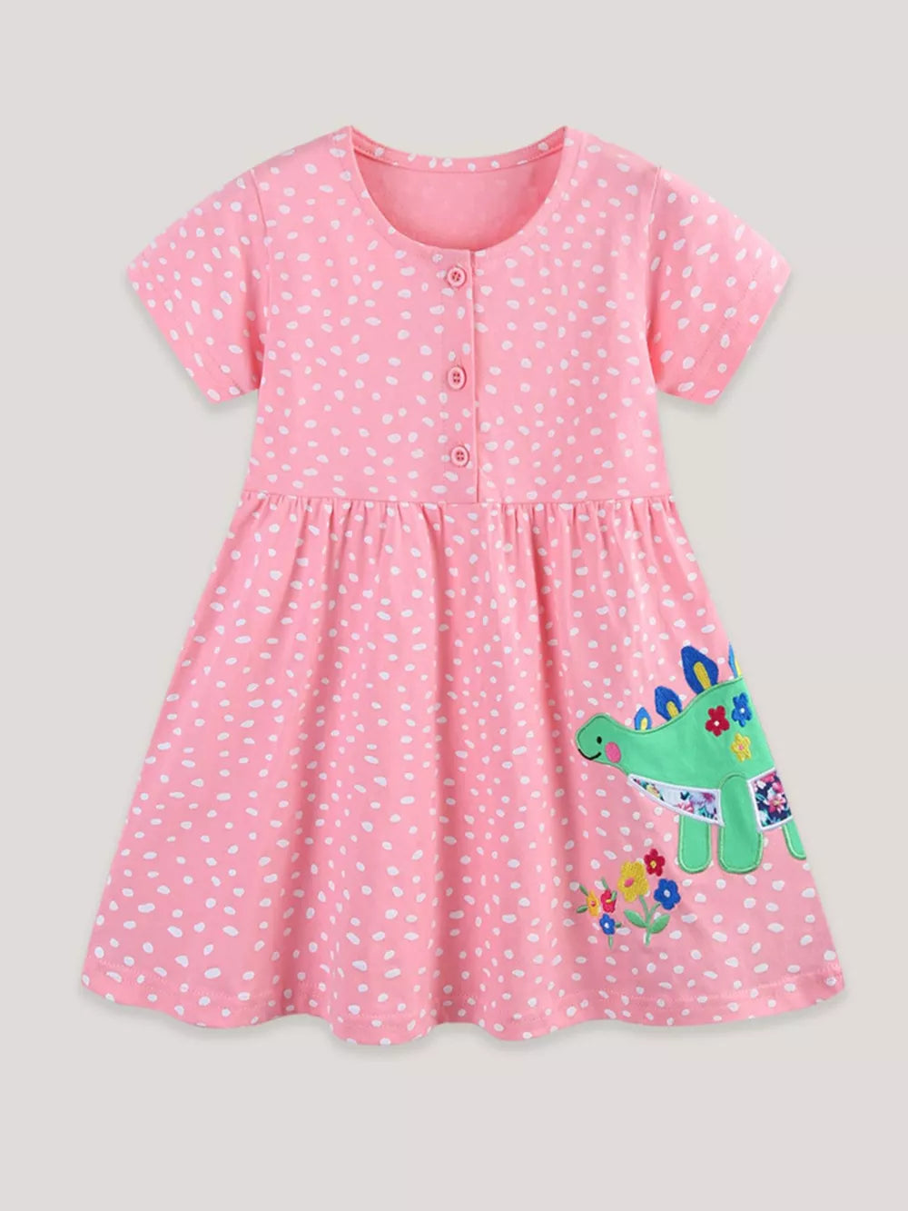 Baby pink polka dot cotton dress with dinosaur appliqué and floral detail.