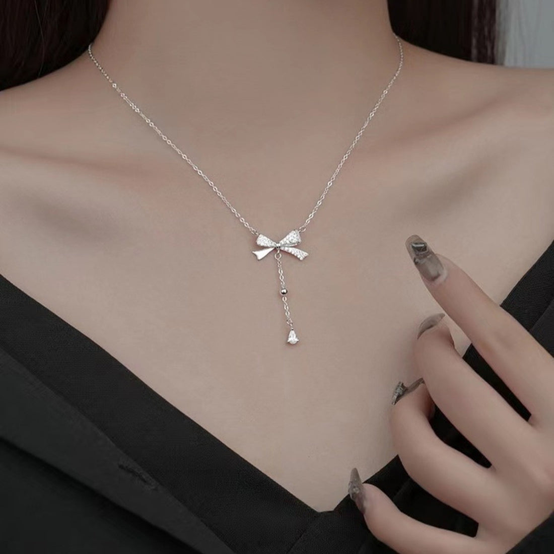 necklace in silver featuring bow detail and NA fit