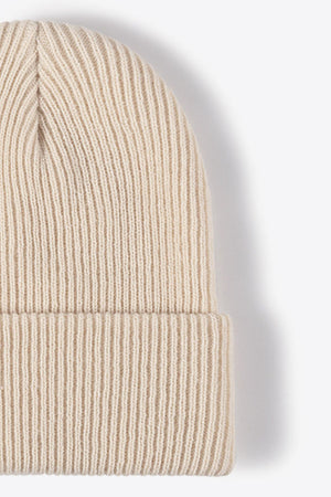 Beige ribbed knit beanie with a cuffed hem