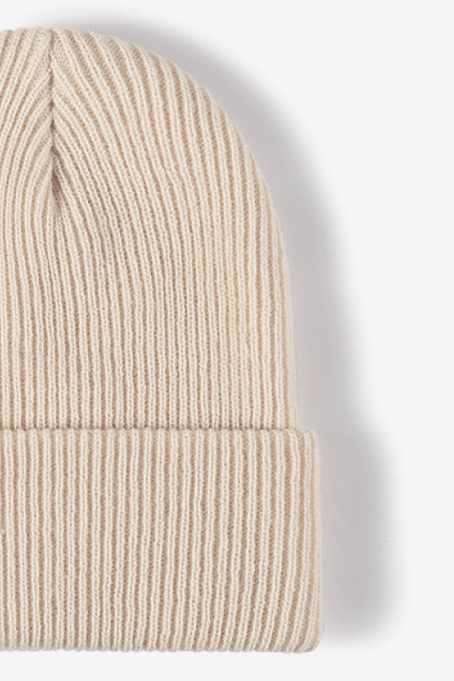 Beige ribbed knit beanie with a cuffed hem