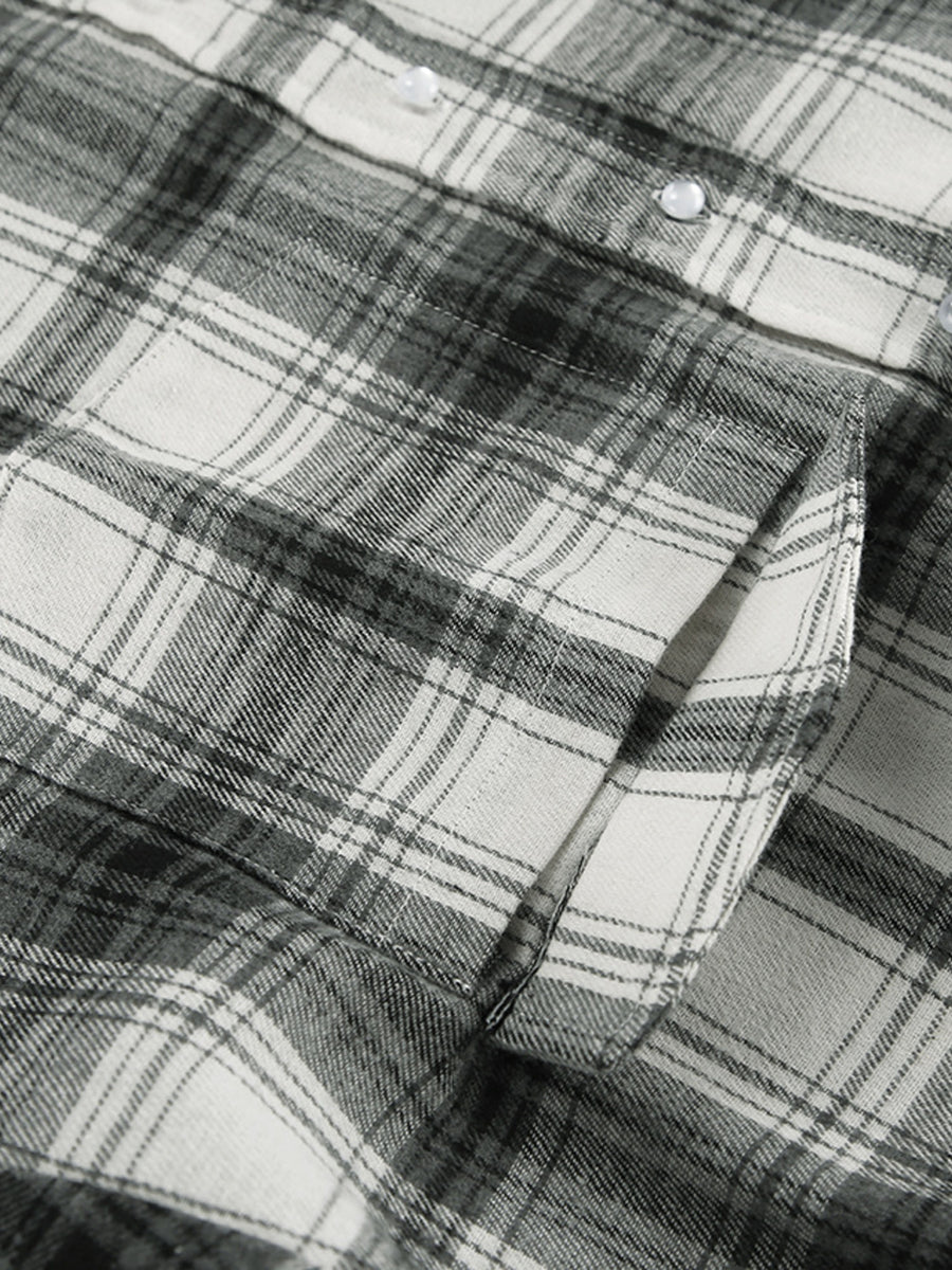 Button-up long sleeve cotton shirt in black and white plaid with a chest pocket.