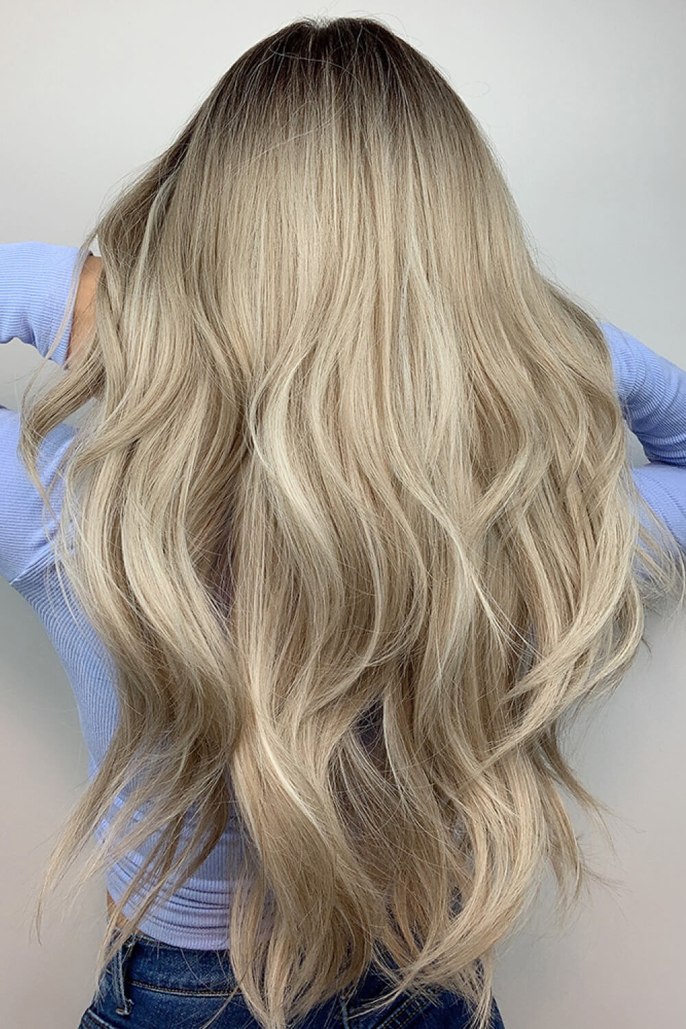 Ombre wave frontal wig in ash blonde balayage with dark roots and loose waves.