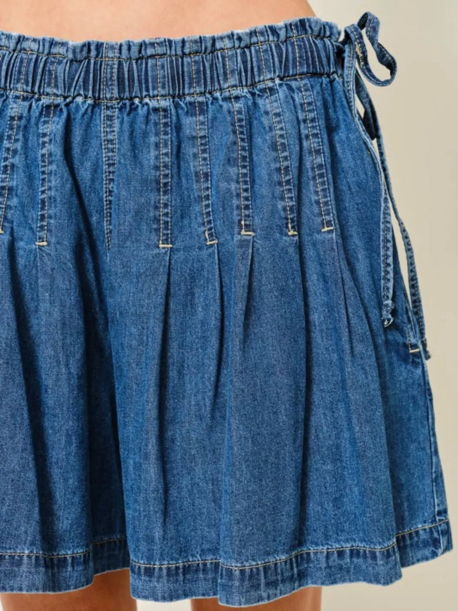 Medium blue denim-effect shorts with ruched waist and drawstring detail.