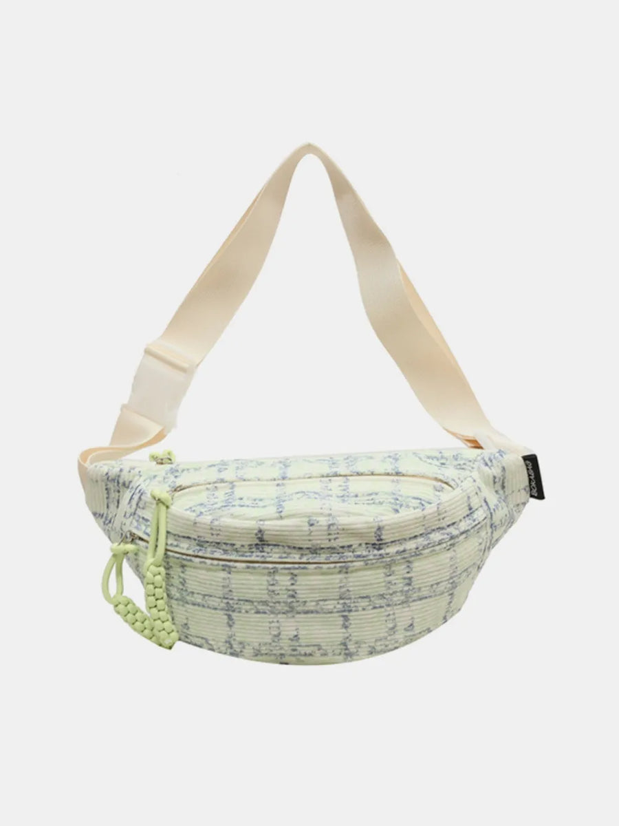 Textured tweed belt bag in light green with braided pulls and cream strap.