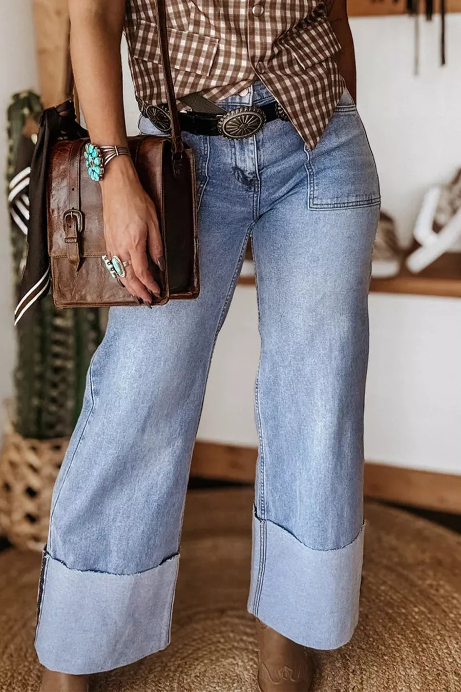 Light wash denim wide leg jeans with large cuffs and front pockets