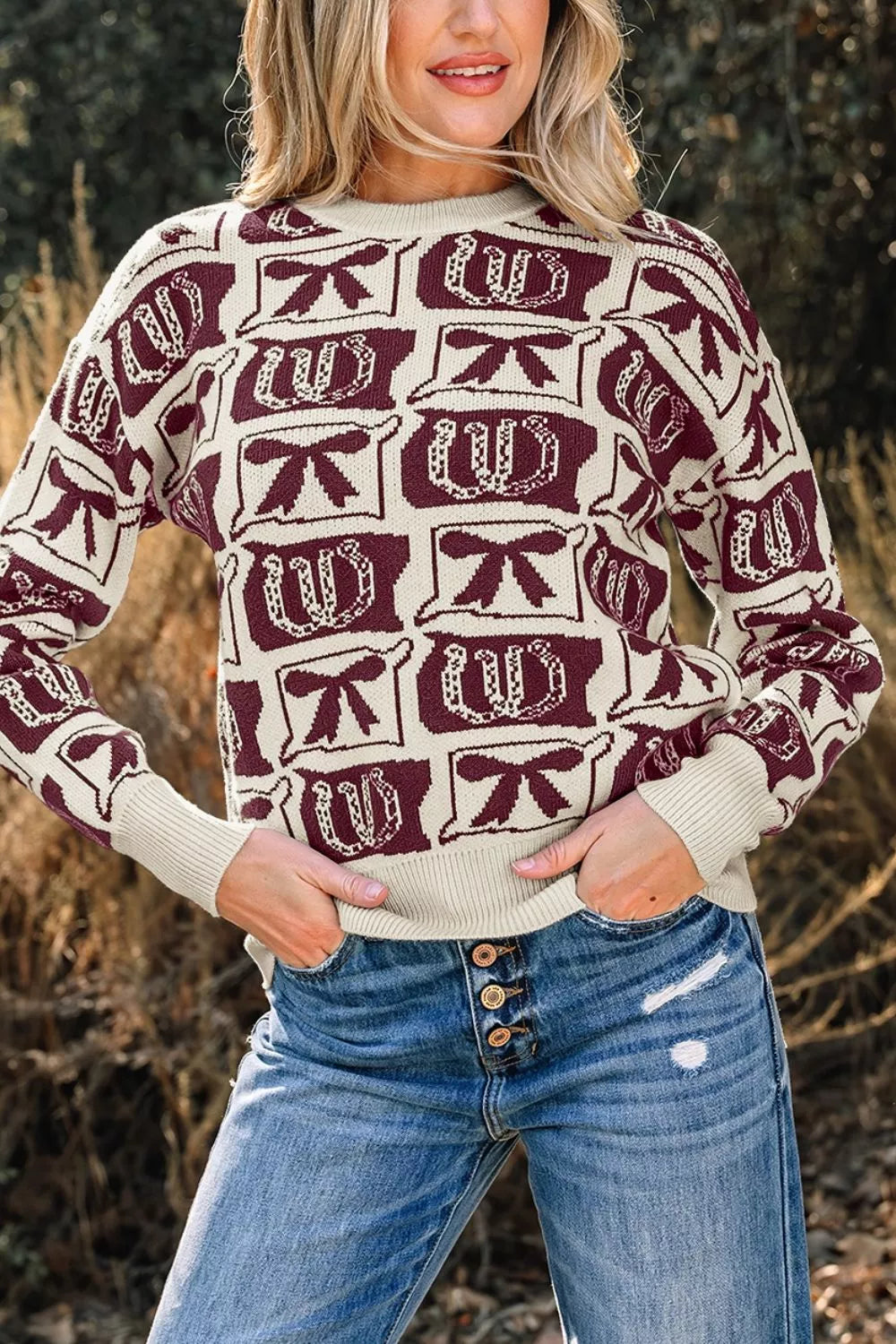 ivory pullover sweater with bow and horseshoe motif and crew neck