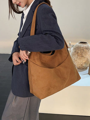 handbag in camel featuring exterior slip pocket and loose fit