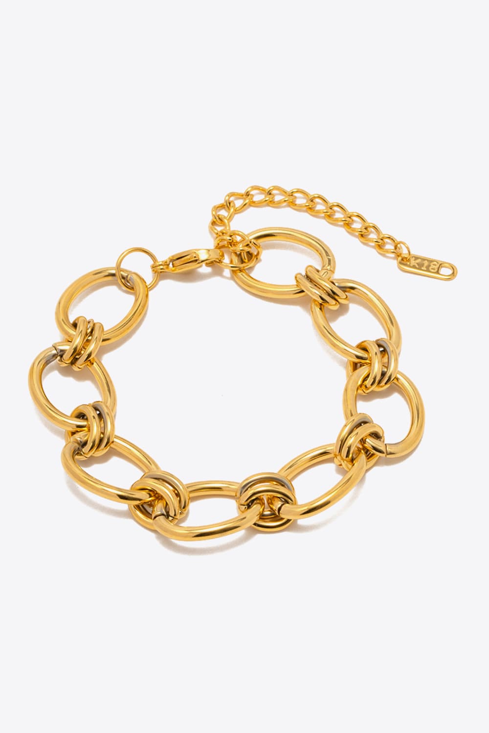 Chunky gold knot link bracelet with adjustable chain and lobster clasp.
