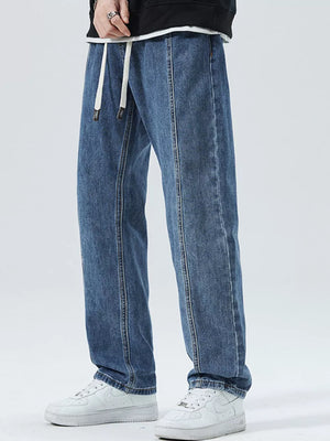Men's light blue 100% cotton loose-fit jeans with drawstring waist and front seam detail.