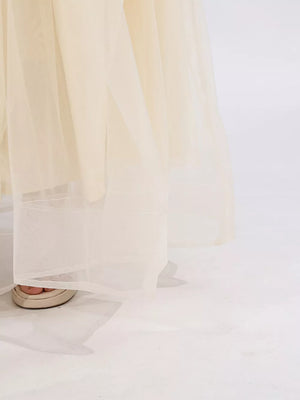 Cream tulle maxi skirt with subtle sparkle detail and a sheer hem.