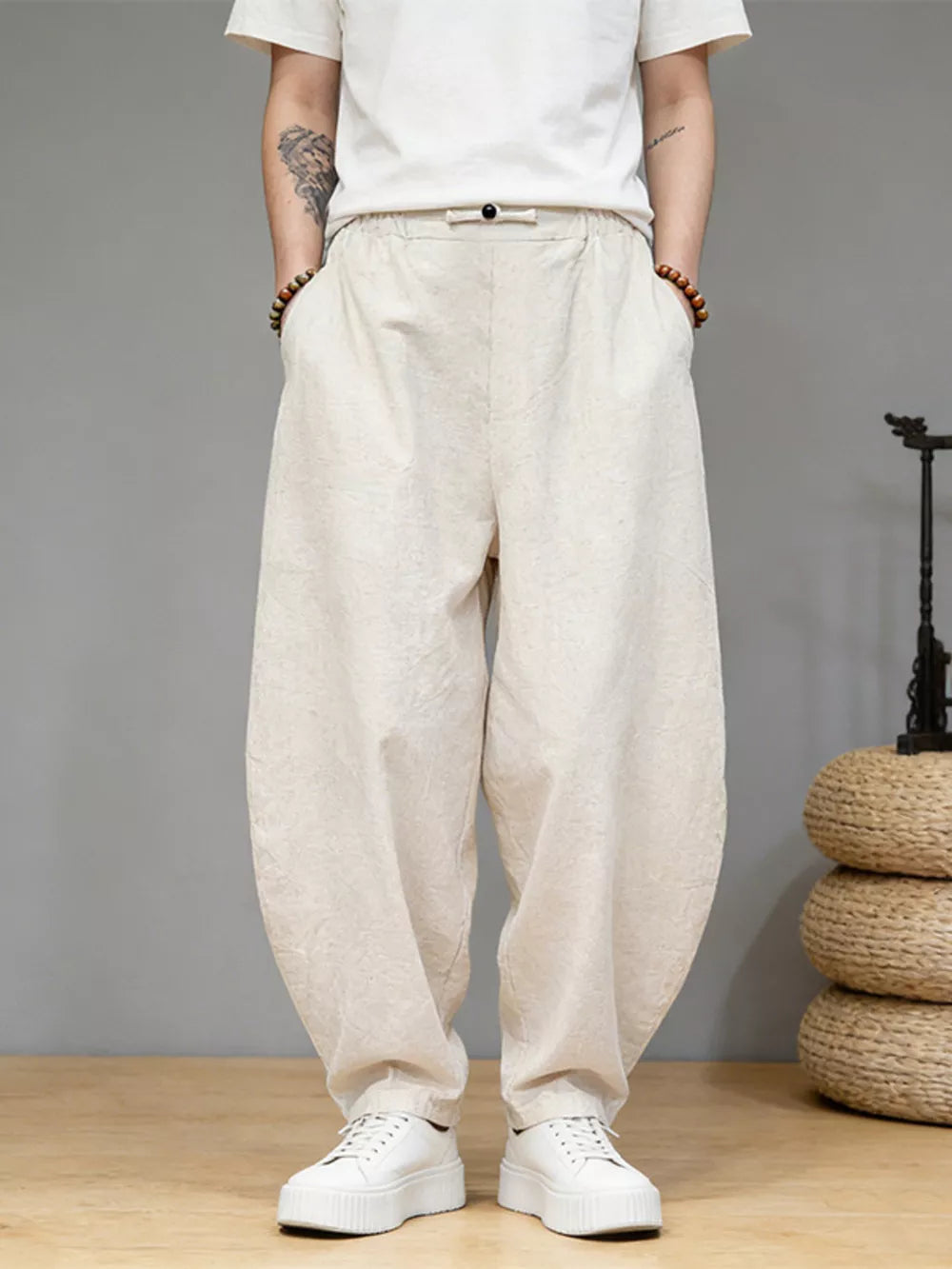 Men's relaxed fit ivory sweatpants with pockets and a drawstring waist.
