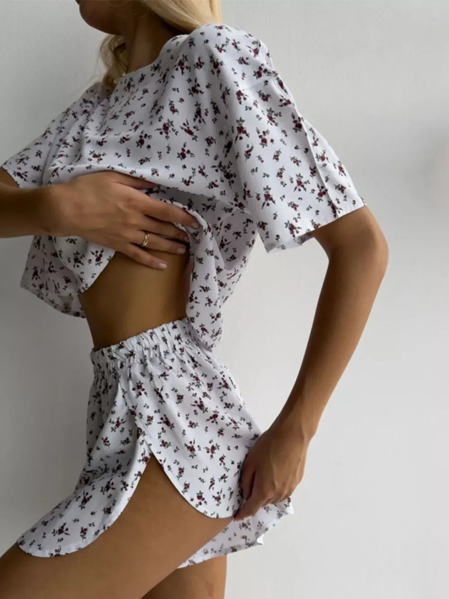 White floral print lounge set with relaxed fit top and split hem shorts.