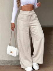 wide-leg pants in light beige featuring pocketed and wide-leg fit