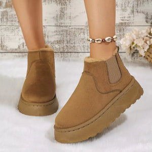 Caramel suede round toe platform ankle boots with faux fur lining and elastic side panels.