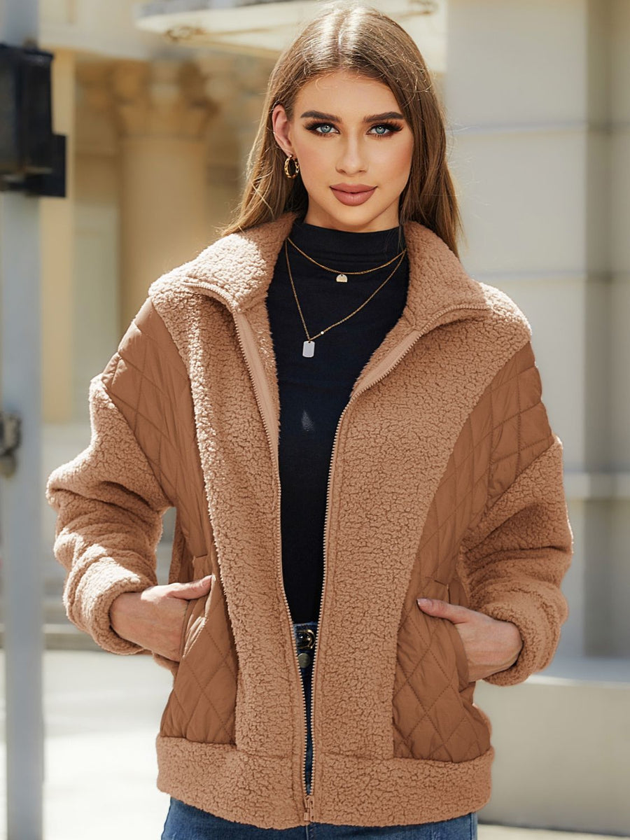 Camel quilted jacket with sherpa panels and zip front, featuring a stand-up collar.