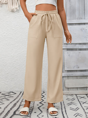 Khaki relaxed drawstring wide-leg pants with front pockets and a tie waist.