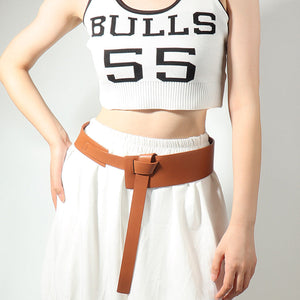 Caramel leather belt with a tied waistband and elongated tail, styled over a white skirt.