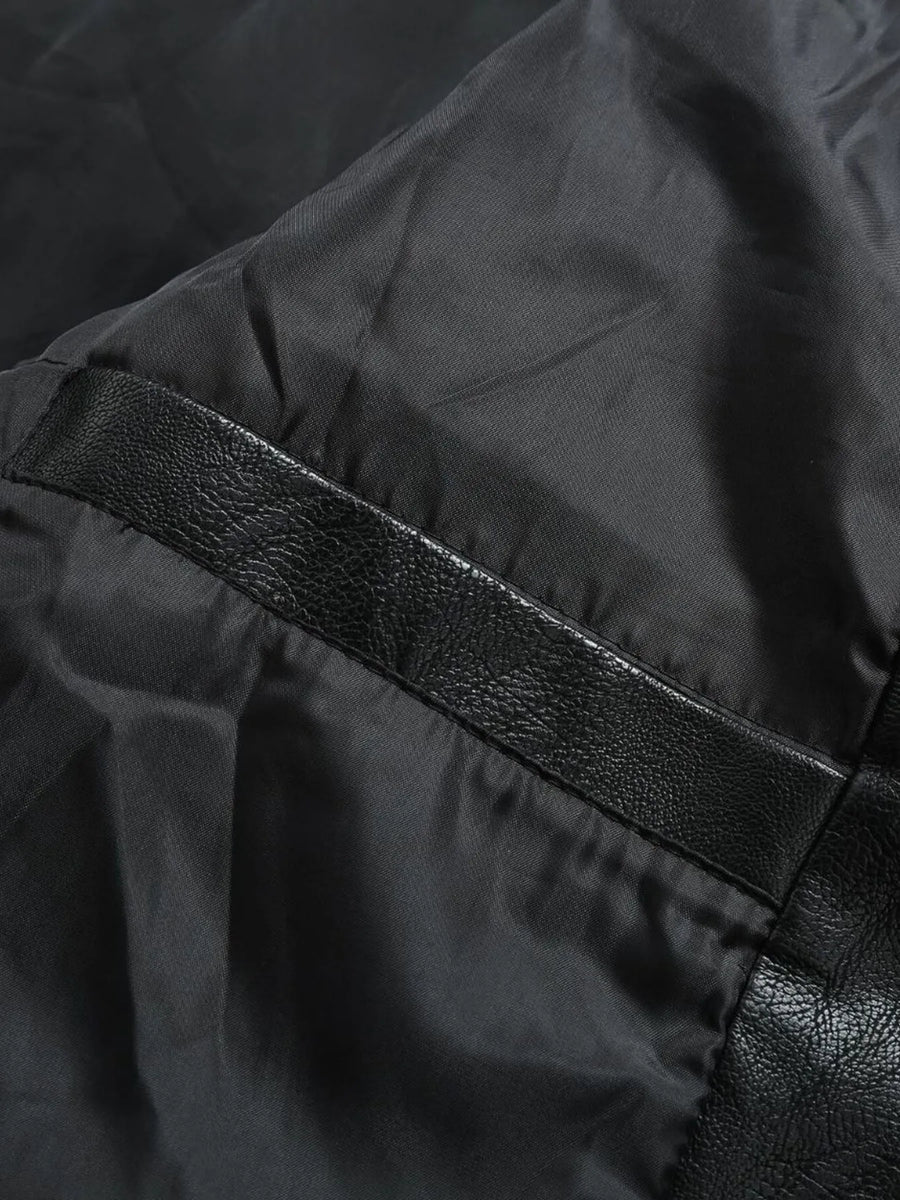 Black moto jacket detail with faux leather trim and satin lining.