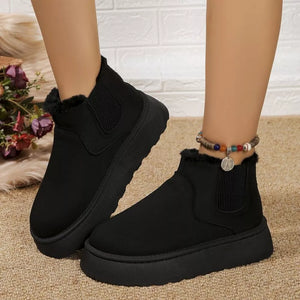 Black suede round toe platform ankle boots with faux fur trim and elastic side panels.