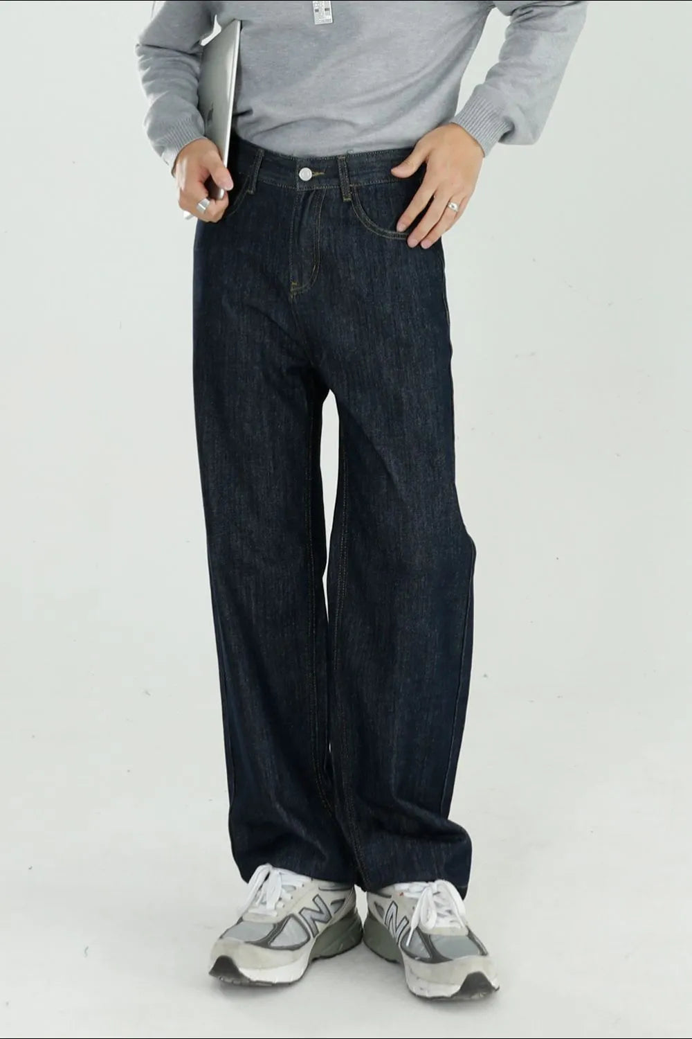 Dark wash denim jeans with a modern, relaxed wide-leg fit.