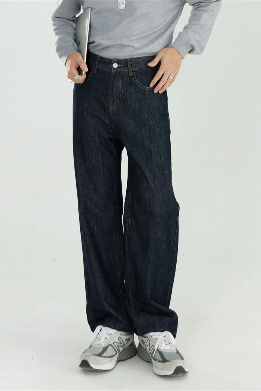 Dark wash denim jeans with a modern, relaxed wide-leg fit.