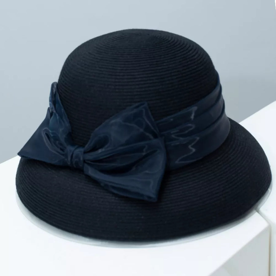 Black straw sun hat with a large satin bow detail.