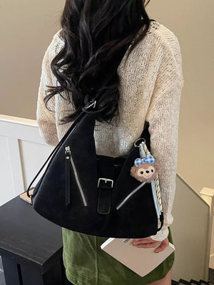 Black distressed leather buckle shoulder bag with diagonal zippers and charm