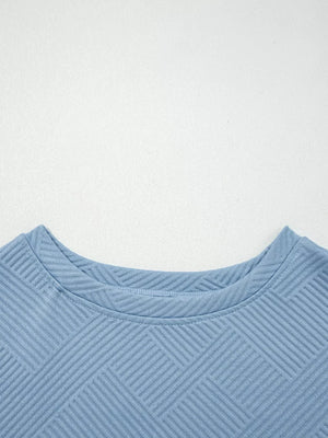 Light blue textured drawstring set with a geometric pattern and crew neck.