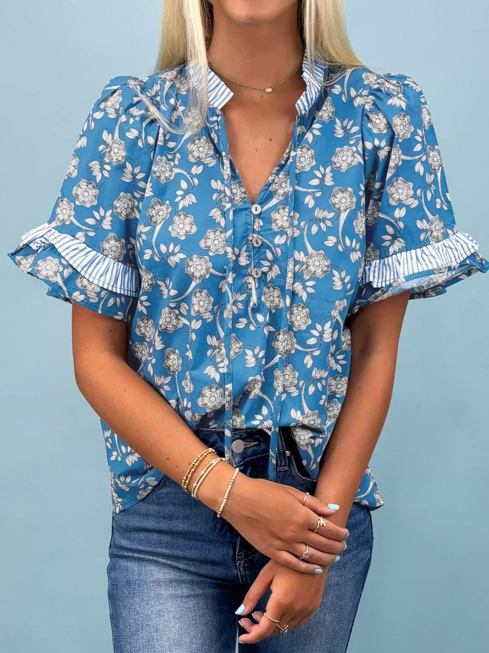 Blue floral cotton blouse with ruffle sleeves and tie neck