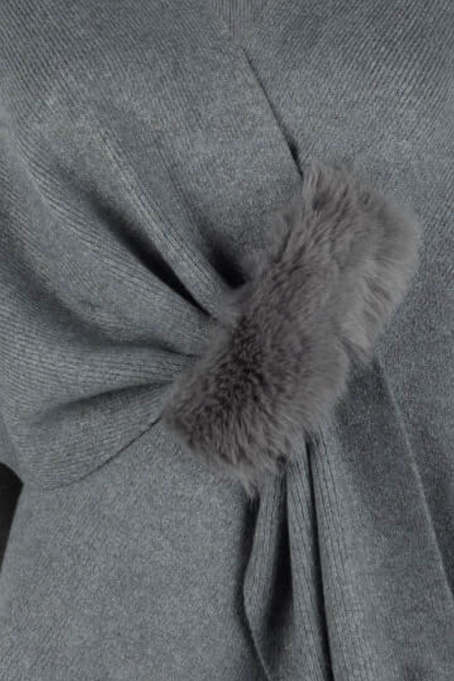 Charcoal knit cape with draped detail and fur trim accent.